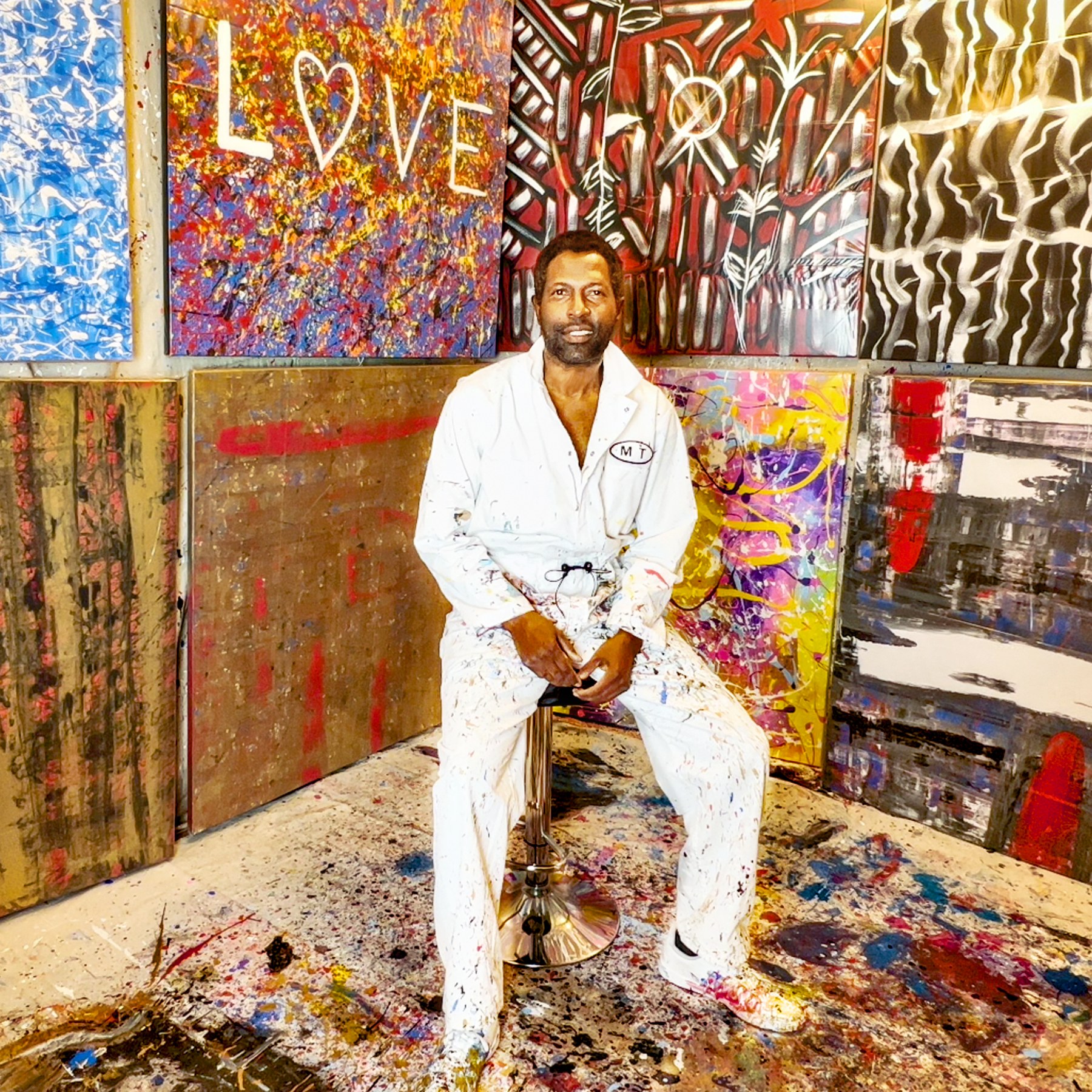 Abstract artist Michael Terry in his painting studio surrounded by colorful contemporary fine art
